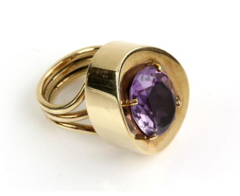 A bespoke amethyst ring, with a central oval cut amethyst weighing an estimated 8.00 carats, claw set in a wide concave, oval