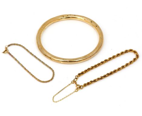 Three gold bracelets, including a rope bracelet with a safety chain, measuring 19.5cm, a bi-colour rope bracelet measuring 18