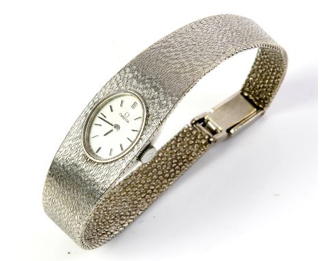 Omega, a ladies white gold wristwatch, the signed oval white dial with baton hour markers, fitted with a 17 jewel, calibre 48