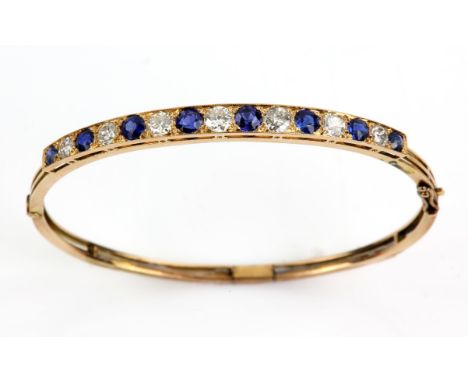 Sapphire and diamond bangle, seven old cut diamonds, with an estimated total diamond weight of 1.00 carats, with eight altern