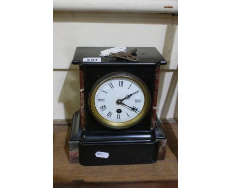 A Victorian Black Marble Encased Mantle Clock With White Circular Dial