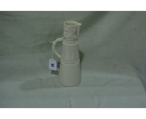 A Royal Worcester Cream Glazed Conical Jug With Stylised Branch And Blossom Handle