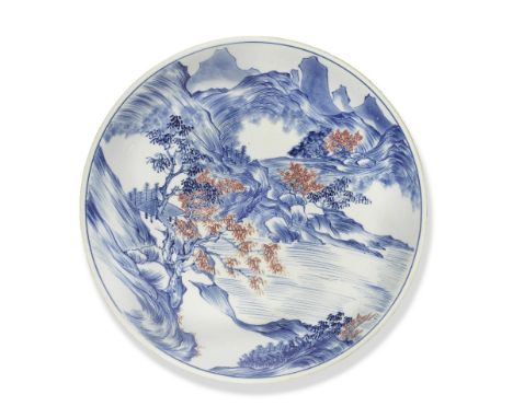 A BLUE AND WHITE AND COPPER-RED 'MASTER OF THE ROCKS' SAUCER DISHEarly KangxiPotted with deep rounded sides rising to a sligh