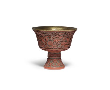 A RARE CARVED CINNABAR LACQUER 'LANÇA' STEM BOWLQianlong Expertly carved around the steep flaring exterior sides with eight l