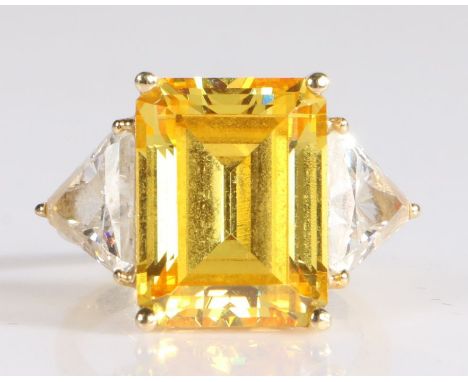 14 carat gold ring having a large emerald cut yellow stone to the centre with trillion cut white stones to each shoulder, 8.2