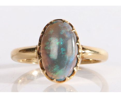 A black opal ring, the cabochon cut opal within a claw setting, 4.2 grams, ring size Q