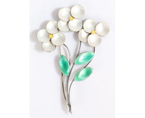 A silver and enamel flower brooch, comprised of three elegant silver stems each with a yellow and white enamel flower head an