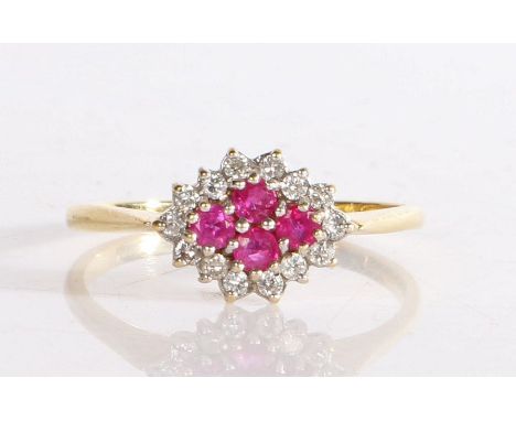 An 18 carat gold ruby and diamond ring, the head set with four round cut rubies surrounded by diamonds, ring size U weight 3.