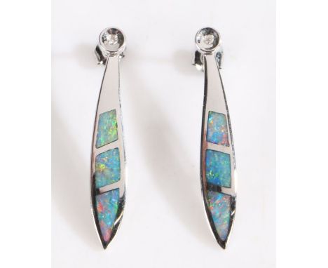 A pair of 14 carat white gold and black opal pendant earrings, each pendant comprised of three pieces of sliced opal set in a