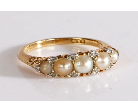 A Victorian 18 carat gold pearl and diamond set ring, with a row of five pearls and eight diamonds to the head, 4.2 grams, ri