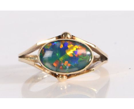 A black opal set ring, the cabochon cut triplet opal set to angled shoulders, 4.2 grams, ring size P