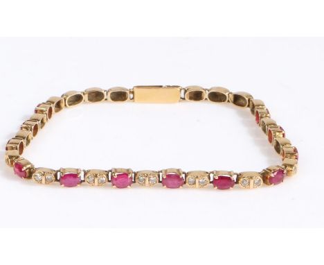 A yellow metal diamond and ruby bracelet, with claw mounted oval rubies intersected by diamonds, 18cm long weight 7.0 grams (