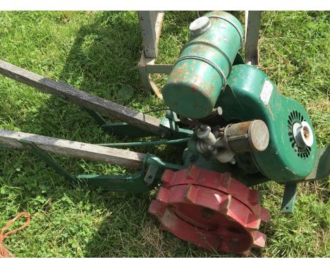 A Vintage Villiers garden tractor with double red painted steel wheels single cylinder engine in good condition with wooden s