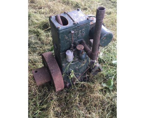 A Vintage static engine a single cylinder Lister H062 with external flywheel finished in green.