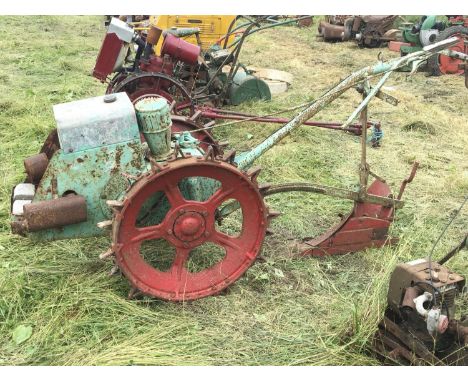 A vintage Trusty Tractor type. With steel wheels and single farrow plough attachment.