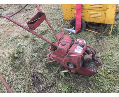 A vintage Barford Atom small holders plough with enclosed double wheels single cylinder engine finished in red.