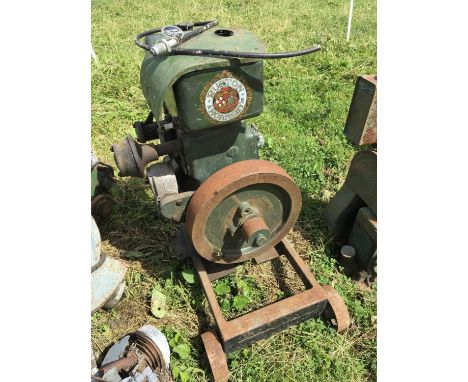 A rare Vintage Ruston Hornsby gas driven static engine with a large external cast steel fly wheel on a cast stand. Made in Li
