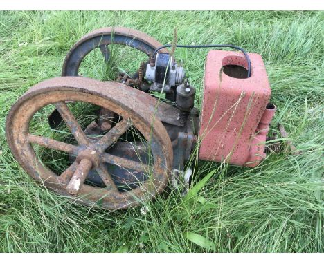 A Vintage static cast iron engine with two belt wheels single long stroke horizontal piston. With attached Magneto.