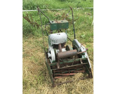 A Vintage lawnmower a push a long mower vintage chainsaw and one other small universal use garden tractor (4)