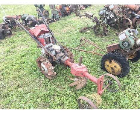 A Scarce vintage American tractor hoe with vertical spinning harrow attachment steel wheels  single cylinder engine The Grave