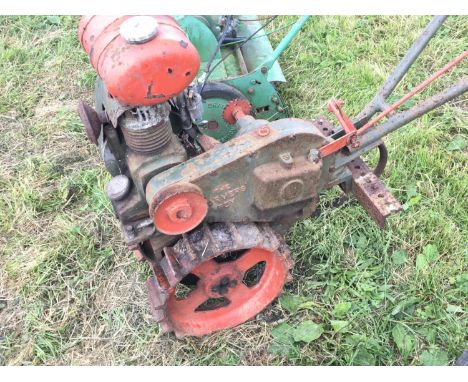 A Vintage small Farmers Boy garden tractor multipurpose with steel wheels fitted with a JAP single cylinder engine and one ot