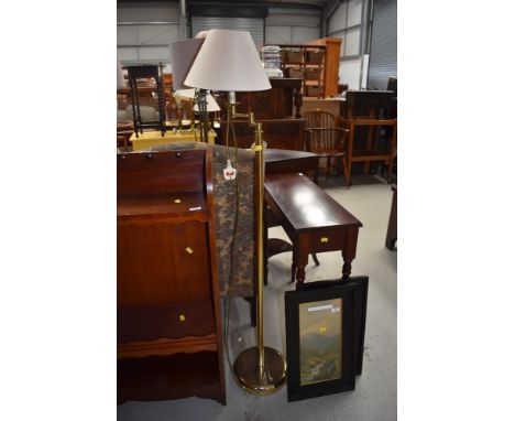 A modern brass standard lamp with adjustable arm