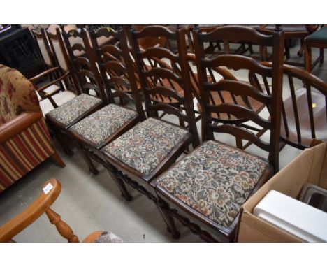 A set of 4 mid century dark stained ladder back dining chairs