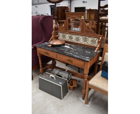 A Victorian stripped washstand with marble top and tile and mirror back
