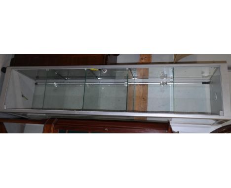 A modern satin metal and glass 5 height free standing display cabinet with lighting to each shelf 