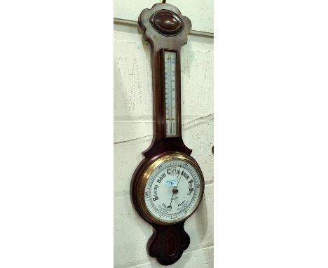 An aneroid barometer in banjo case with white enamel dial by Lloyd Payne &amp; Amiel, Manchester 
