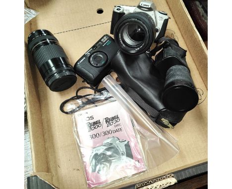 A Canon E0S 300 camera with Sigma Zoom 28-105mm lens, Canon Zoom EF 75-300mm lens, a Canon Sure Shot Max with 38mm lens and a