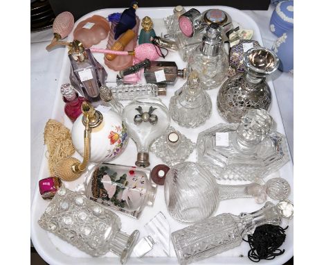 A collection of antique/vintage scent bottles and sprays; a miniature table top display cabinet 