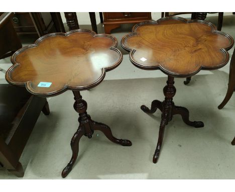 A reproduction mahogany pair of tables by Montague Gower with lobed tops, on tripod legs 