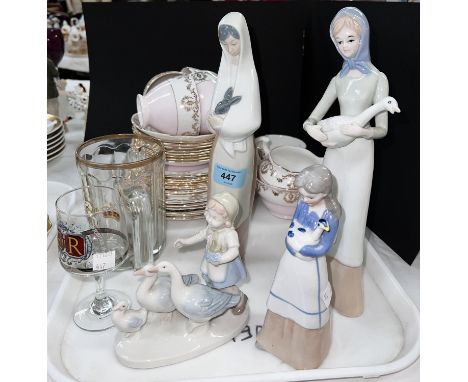 A Nao figure; 3 similar unmarked figures; 2 commemorative glasses; a part tea service in pink and gilt 