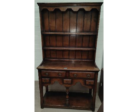A distressed oak small Welsh dresser in the Titchmarsh &amp; Goodwin manner with 2 height delft rack over 2 drawers and 3 spi