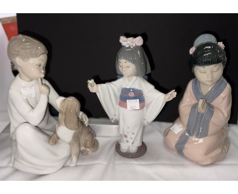 Two Lladro figures:&nbsp; boy with dog &amp; Japanese girl with flowers; a Nao figure similar 