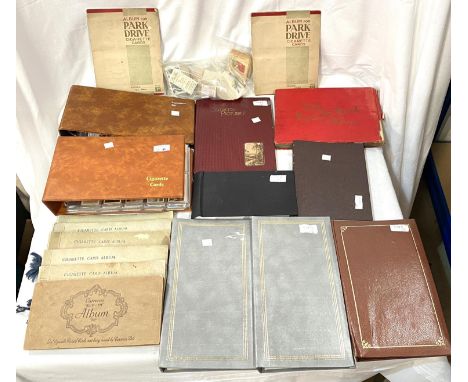 A large selection of cigarette cards in albums and loose, approx. 10 of various sizes; a selection of vintage postcards in al