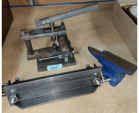 Three small model makers tools, a record anvil, 1 roller and a punch. 