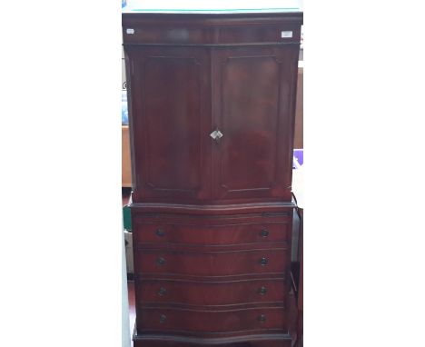 The bow front 4 drawer chest with pull out writing slope & 2 door top 