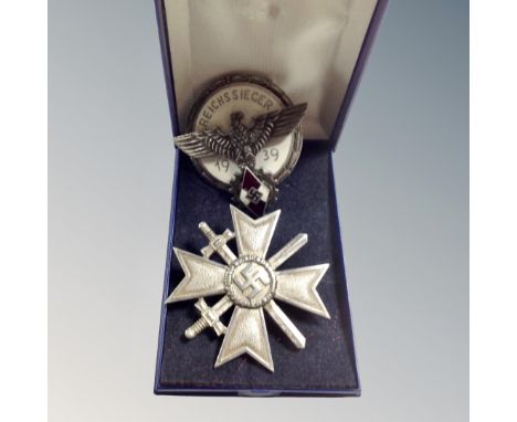 A German WW II Merit of Cross first class badge together with a further Hitler Youth 1939 enamelled badge 