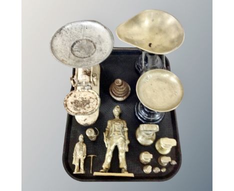 A tray of two pairs of vintage scales with graduated weights, two further brass figures of a coal miner and miniature miners 