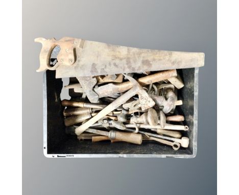 A plastic crate containing vintage hand tools 