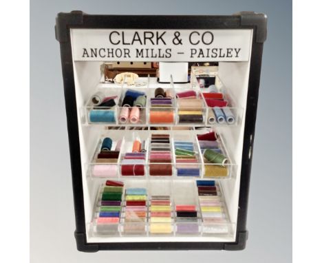 A haberdashery cabinet bearing Clark and Company Anchor mills advertising and quantity of multicoloured threads, height 54 cm