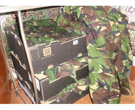 Three boxes of Army camouflage parkas and other similar outfits