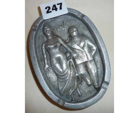 Vintage early 20th c. aluminium humorous risque ashtray, depicting a man grabbing a lady!