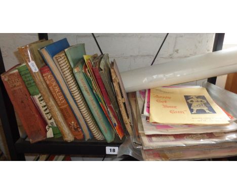 Shelf of old cookery books, programmes, sheet music and posters