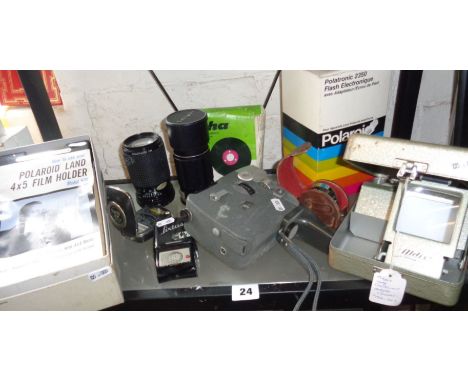 A Polaroid Land 4 x 5 film holder with instruction leaflet in box, a Canon Motor Zoom 8 movie camera, an Aldi's slide viewer,