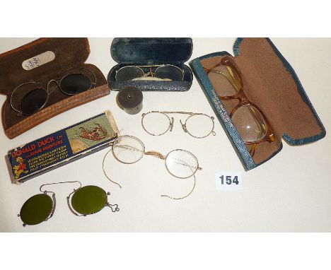 Antique and vintage spectacles, some with cases and coloured lenses - possibly gold rimmed. Inc. a microscope lens and Disney