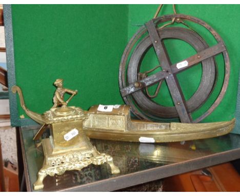 Indian brass inkstand in the form of a gondola (shikara), a cast brass inkwell, a surveyors metal tape measure and a spring b