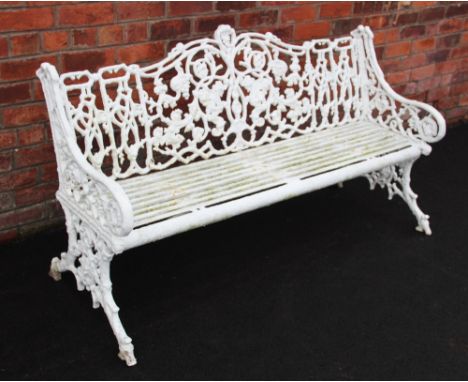 A Victorian painted cast iron Coalbrookdale style garden bench, the cast scrolling openwork naturalistic foliate arched backr